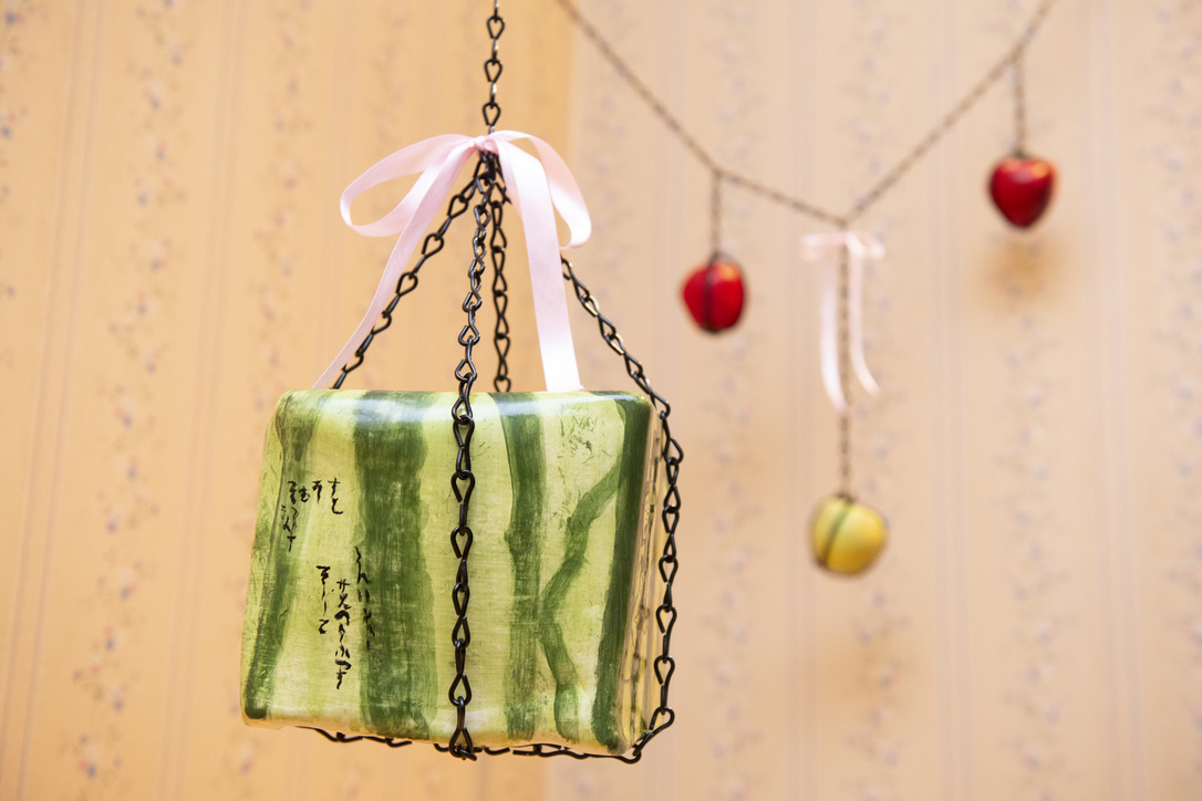 a ceramic square watermelon hanging by chain
